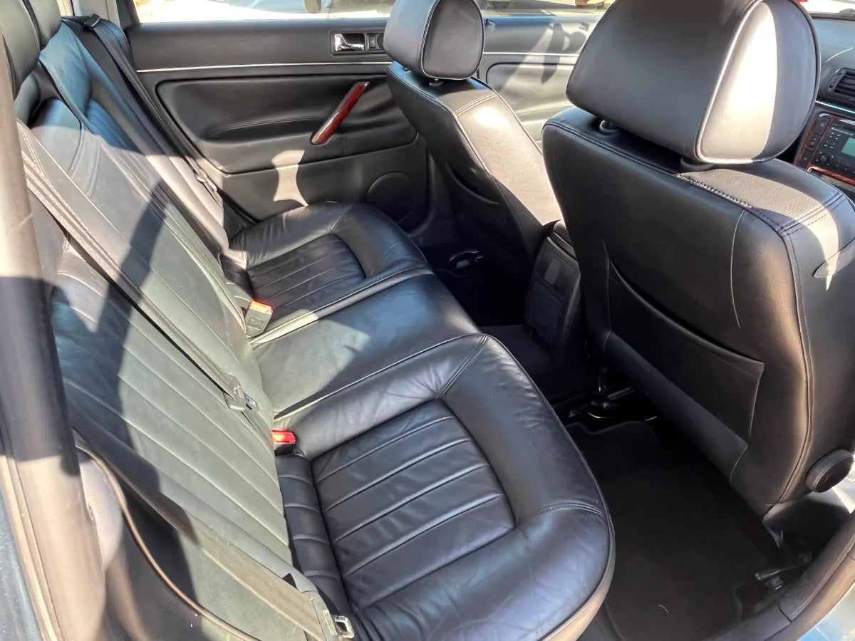 Back seat of a car with black leather seats