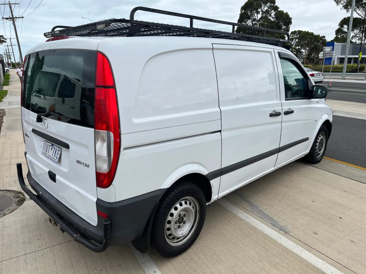 White van with roof rack on a street