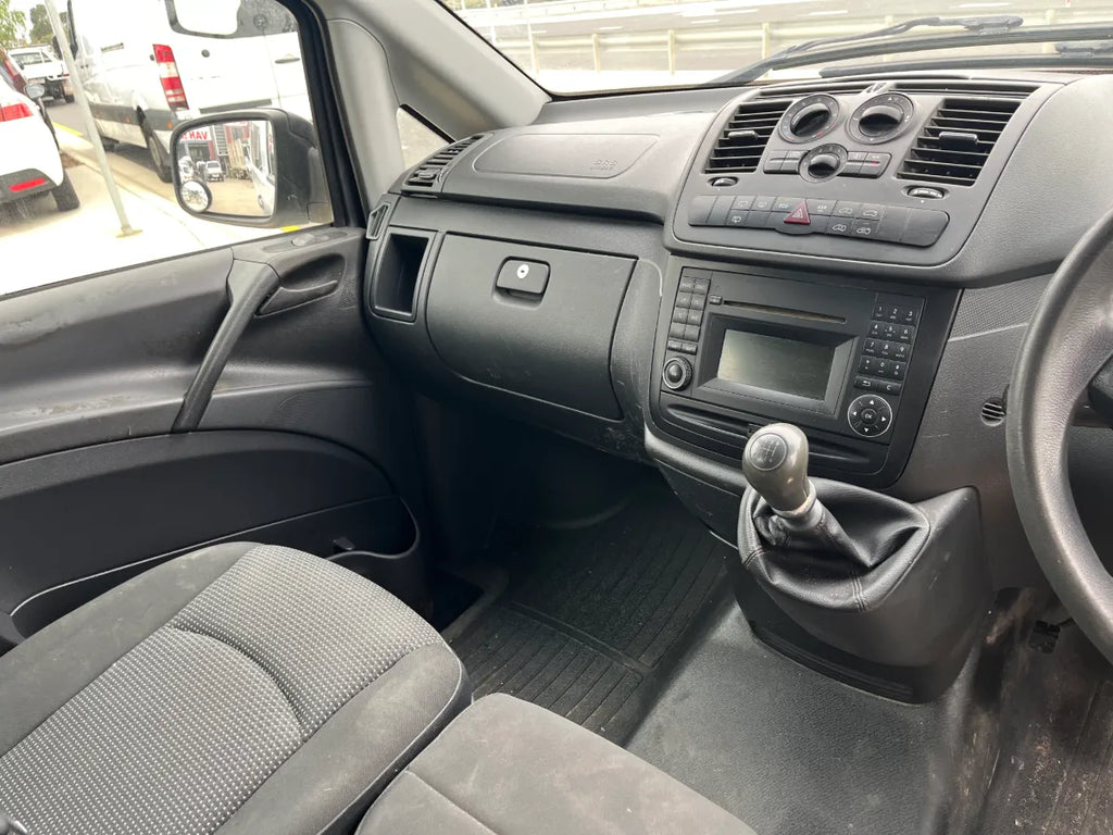 Interior of a vehicle showing dashboard, steering wheel, and seats.