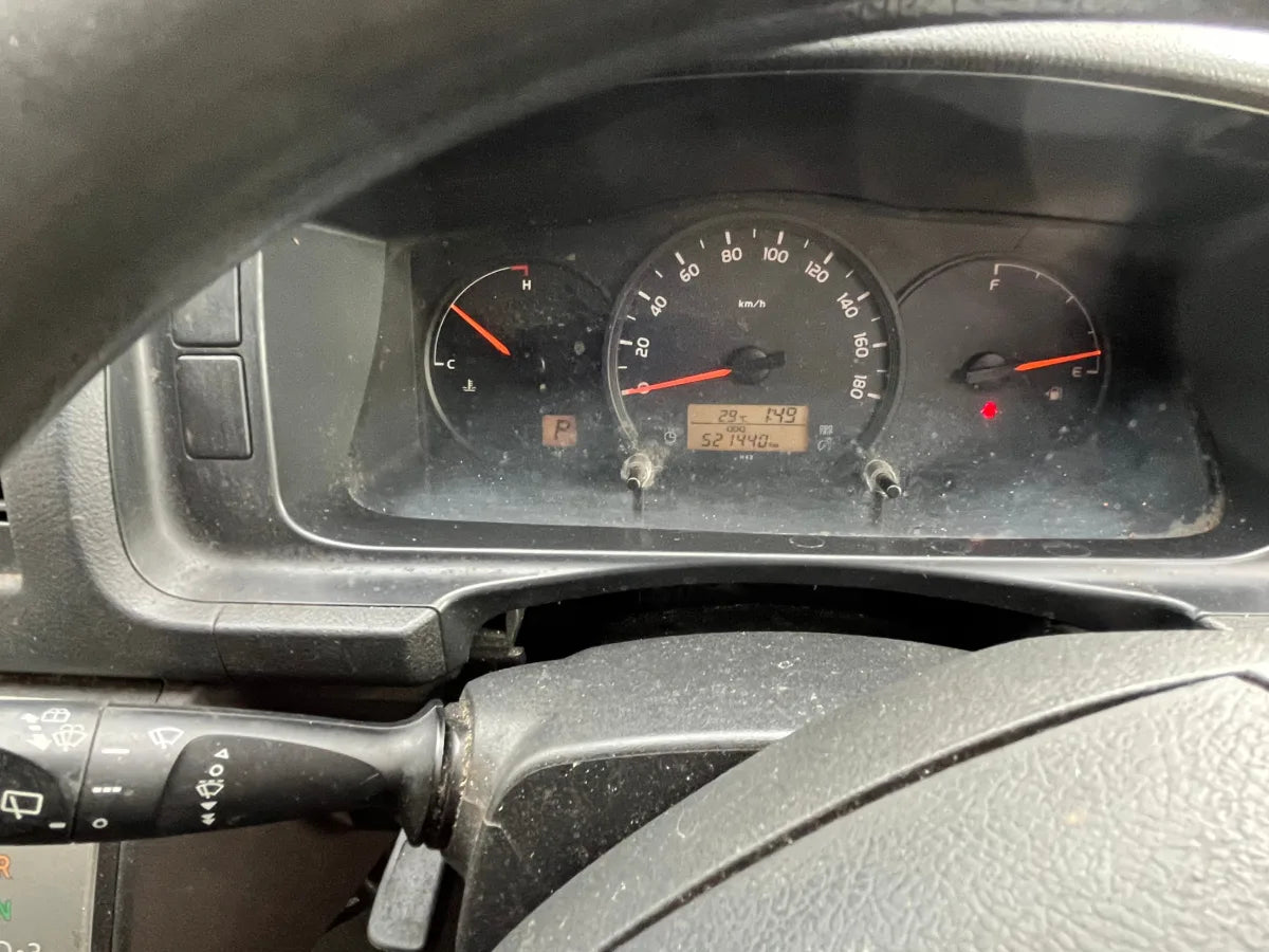 Car dashboard with speedometer and other gauges visible