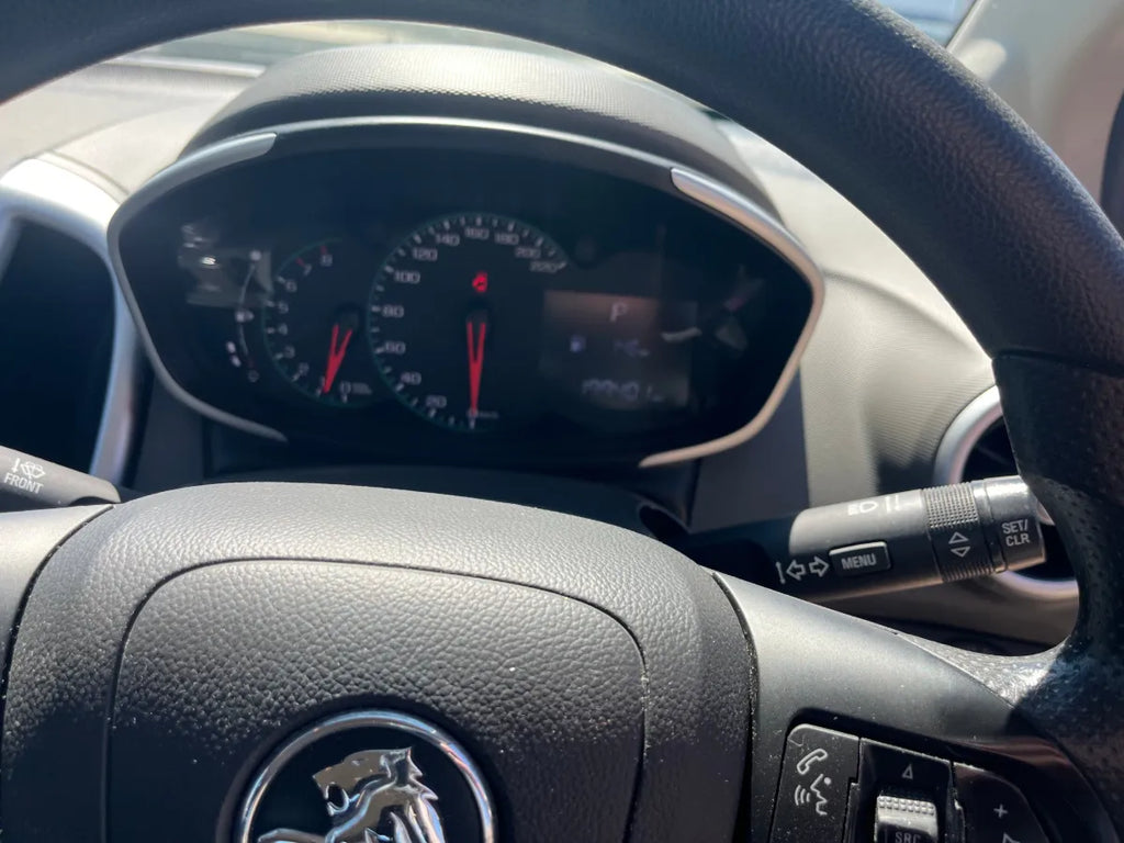 Car dashboard with steering wheel and Peugeot logo