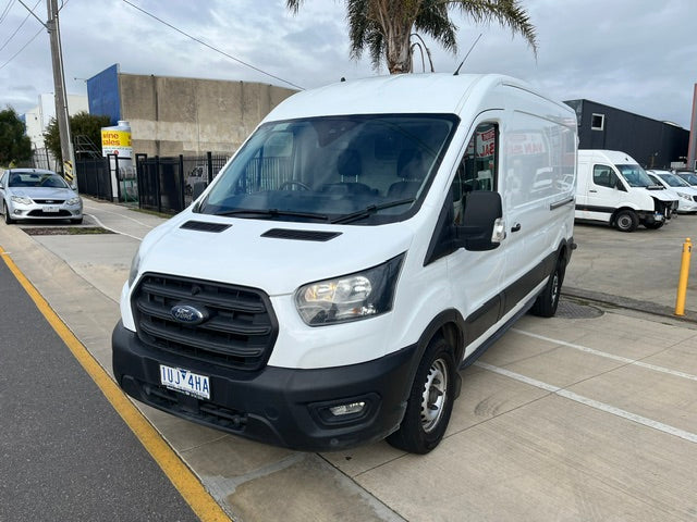 Front three-quarter view of white 2021 Ford Transit long wheelbase mid roof van