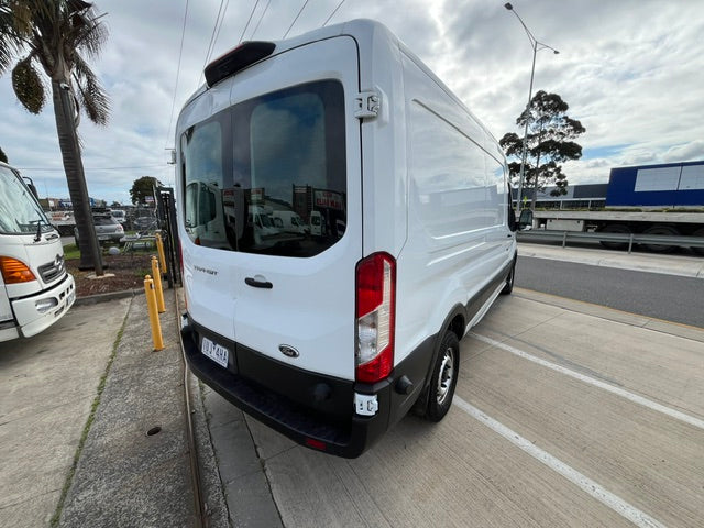 Rear three-quarter view of white Ford Transit